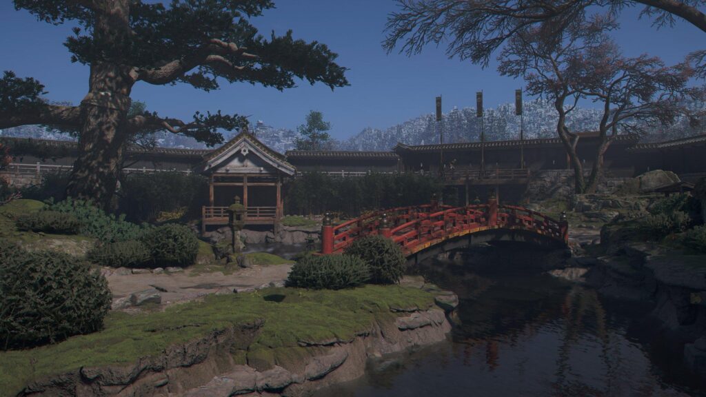 Serene Japanese Garden with Red Bridge and Snow Covered Mountains 4K Desktop Wallpaper