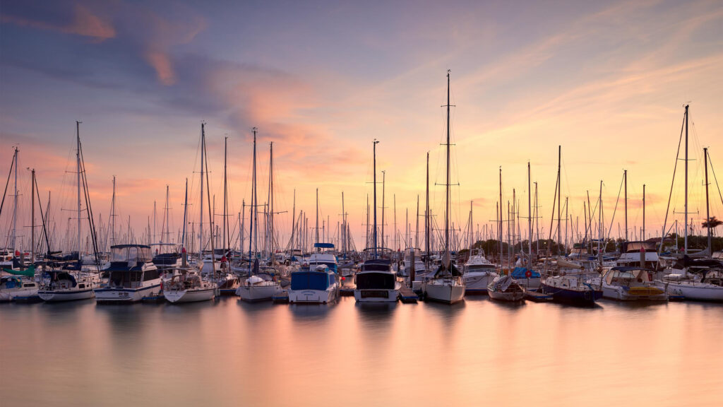 Serene Yacht Marina at Golden Hour Sunset Desktop Wallpaper