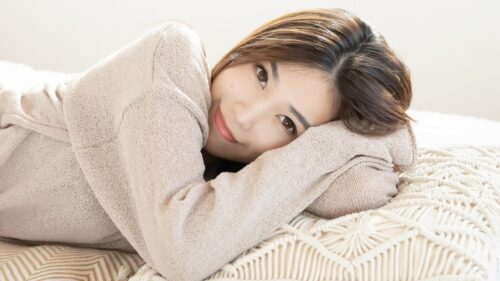 Beautiful Young Woman Resting on Cozy Macrame Bedding 4K Wallpaper