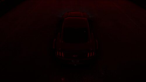Sleek Black Ford Mustang GT in Red Ambient Lighting Desktop Wallpaper