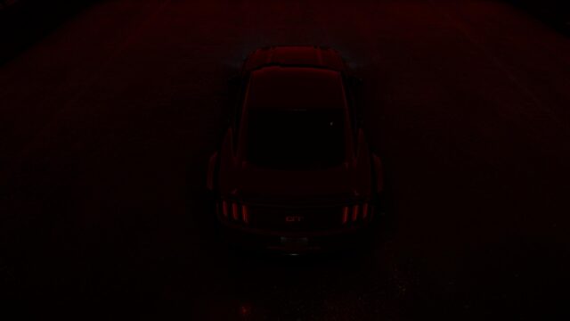 Sleek Black Ford Mustang GT in Red Ambient Lighting Desktop Wallpaper