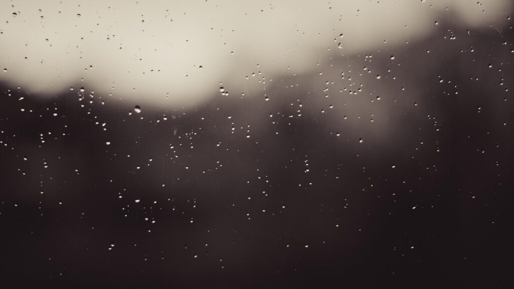 Melancholic Raindrops on Window Glass Dark Aesthetic Desktop Wallpaper
