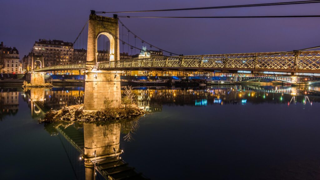 Stunning Nighttime View of the Passerelle du Collège Bridge in Lyon 4K Wallpaper