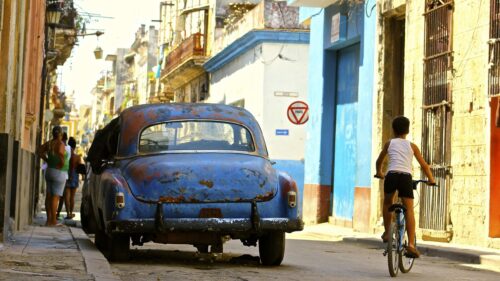 Vintage Blue Car and Child Cycling on Havana Street Desktop Wallpaper