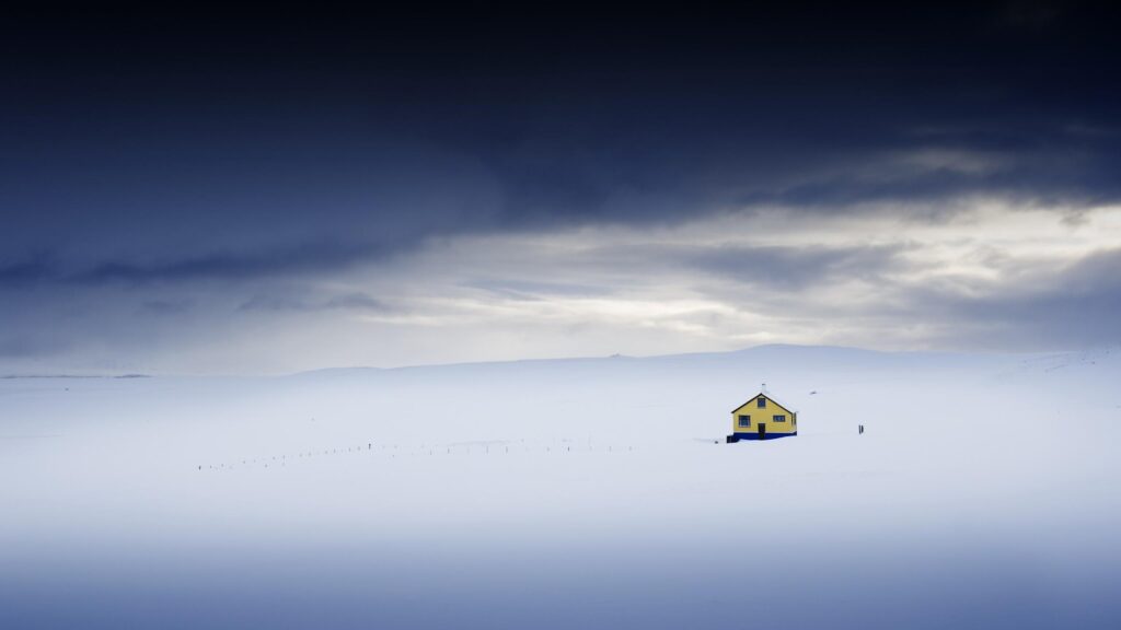 Lonely Yellow House in Vast Snowy Icelandic Landscape Desktop Wallpaper