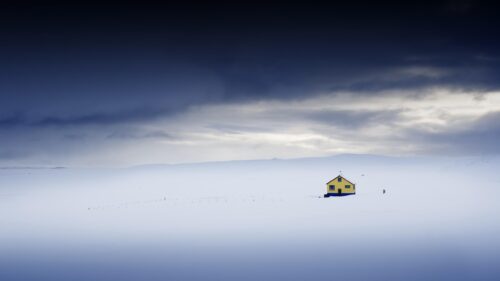 Lonely Yellow House in Vast Snowy Icelandic Landscape Desktop Wallpaper
