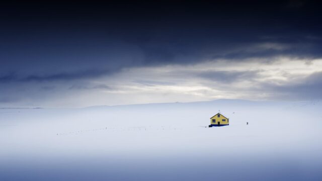 Lonely Yellow House in Vast Snowy Icelandic Landscape Desktop Wallpaper