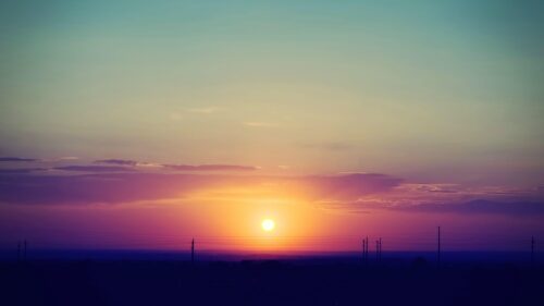 Stunning Purple and Golden Sunset Horizon over Silhouetted Landscape PC Wallpaper