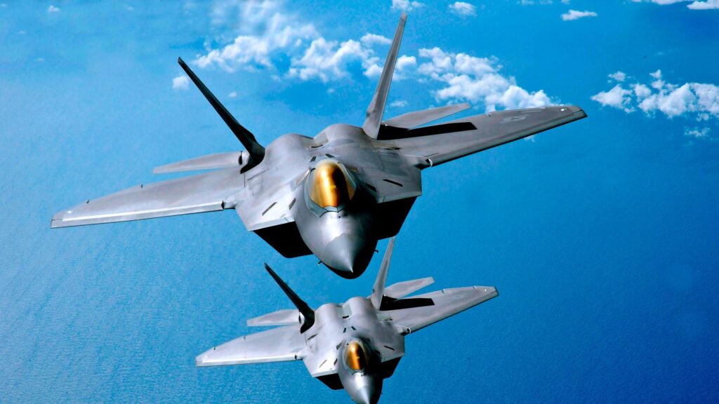 Two F-22 Raptor Stealth Fighter Jets Flying Over the Ocean 4K Desktop Wallpaper