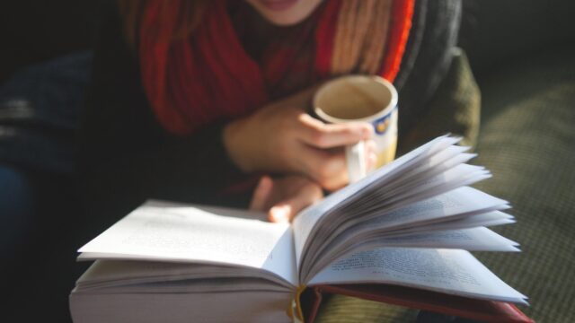 Cozy Woman Reading a Book with a Cup of Coffee Desktop Wallpaper
