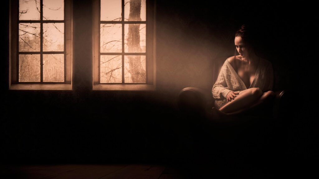 Melancholic Woman Sitting by Window in Sepia Tones PC Wallpaper