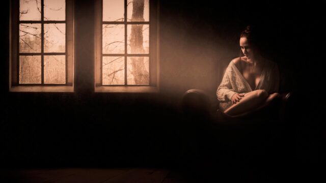 Melancholic Woman Sitting by Window in Sepia Tones PC Wallpaper