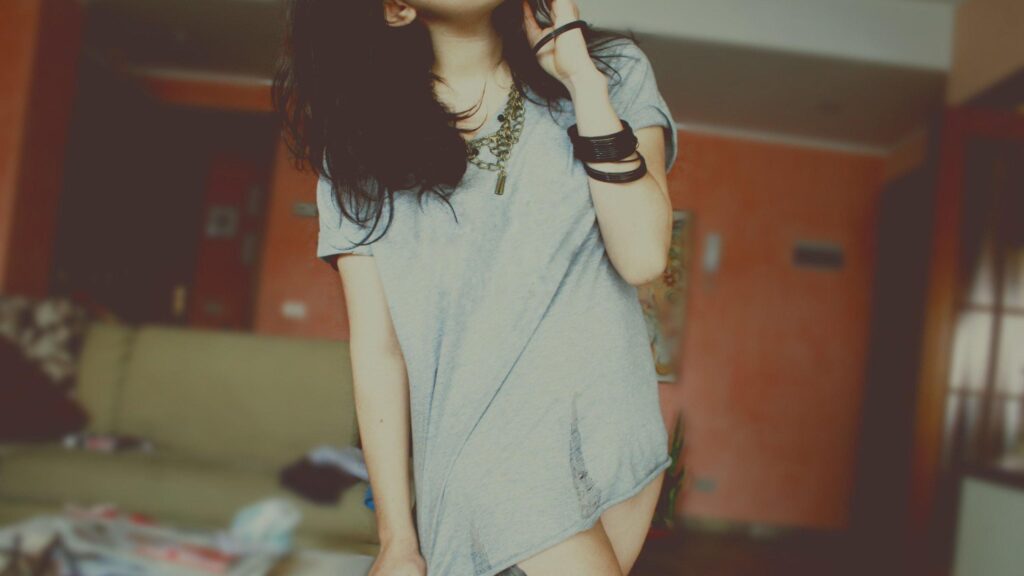 Stylish Young Woman in Casual Grey T-Shirt and Jewelry Desktop Wallpaper