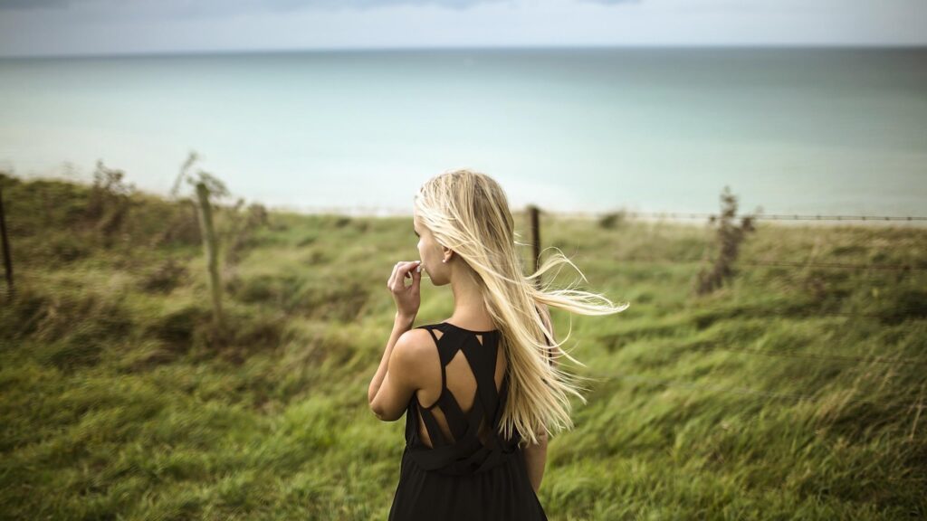 Blonde Woman Standing by the Coastline Scenic Nature View Desktop Wallpaper
