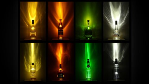 Vibrant Alcoholic Beverage Bottle Collection with Light Refractions 4K Desktop Wallpaper