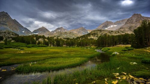 Dramatic Alpine Mountain Landscape with Meadow Stream 4K Wallpaper