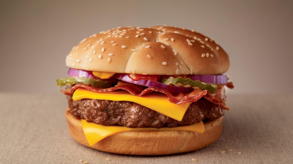 Delicious Gourmet Cheeseburger with Bacon and Fresh Toppings PC Wallpaper