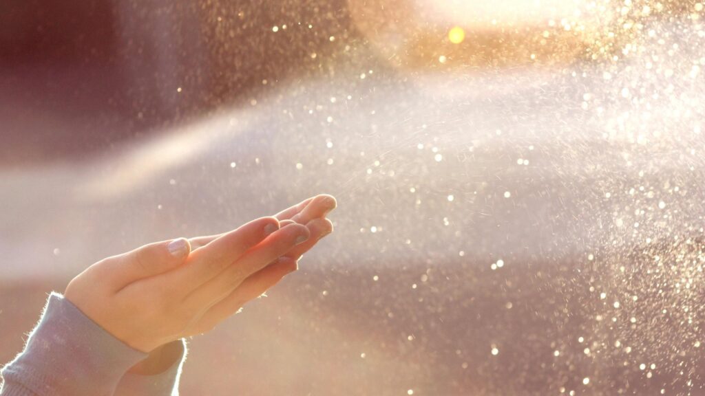 Woman Hands Reaching into Golden Sunlight with Water Mist Desktop Wallpaper