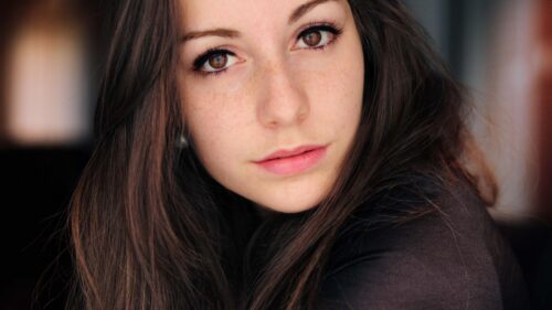 Stunning Portrait of a Young Woman with Brown Eyes and Freckles 4K Desktop Wallpaper