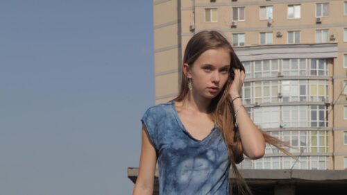 Stunning Young Woman in Blue Tie-Dye Shirt Urban Portrait Desktop Wallpaper