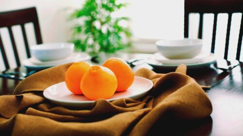 Fresh Oranges on a Rustic Dining Table Aesthetic Desktop Wallpaper