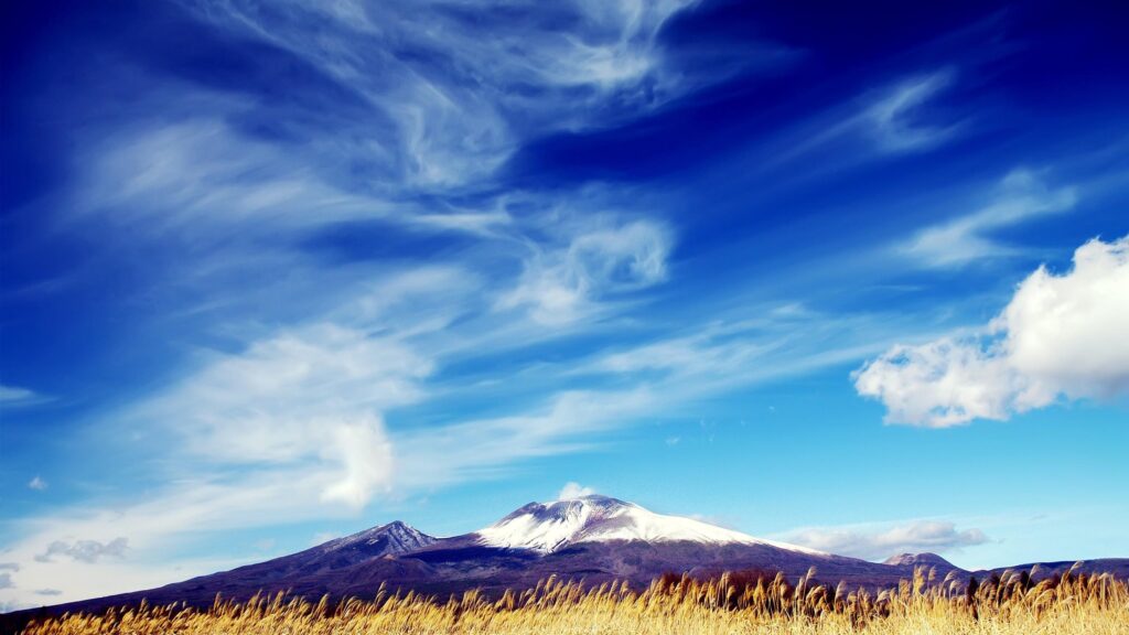 Stunning Snowy Mountain Peak Under Vibrant Blue Sky 4K Desktop Wallpaper