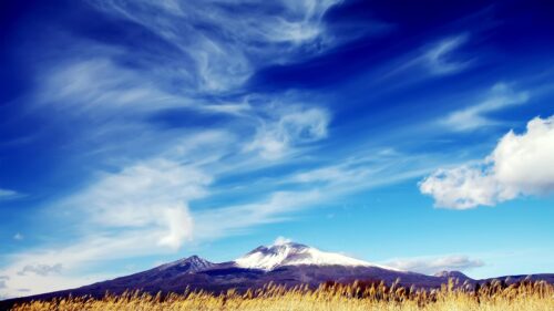 Stunning Snowy Mountain Peak Under Vibrant Blue Sky 4K Desktop Wallpaper