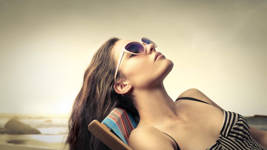 Relaxed Woman Sunbathing in Striped Outfit Desktop Wallpaper