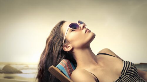 Relaxed Woman Sunbathing in Striped Outfit Desktop Wallpaper
