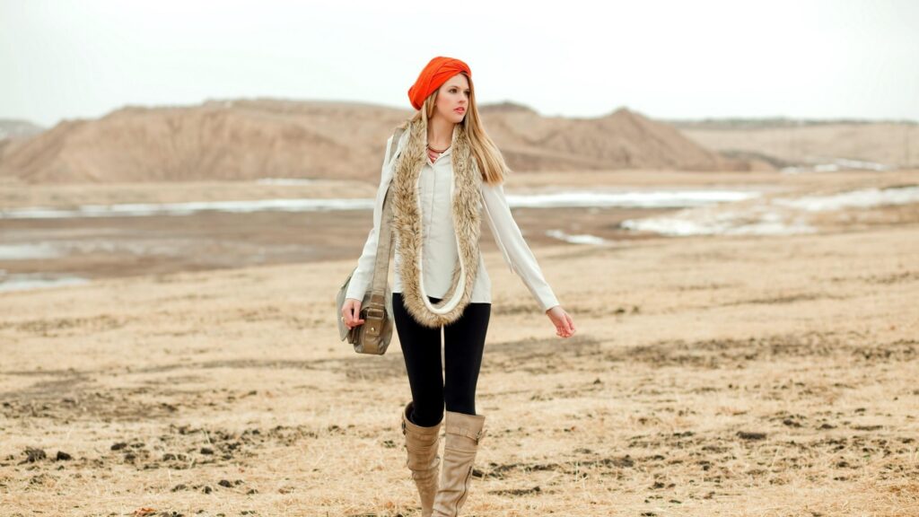 Stylish Fashion Model Walking in a Rustic Open Landscape Desktop Wallpaper