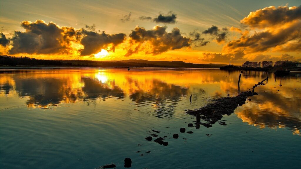 Stunning Golden Sunset Reflection over Calm Lake 4K Wallpaper