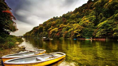 Stunning Autumn Landscape with Boats on Arashiyama River 4K Desktop Wallpaper