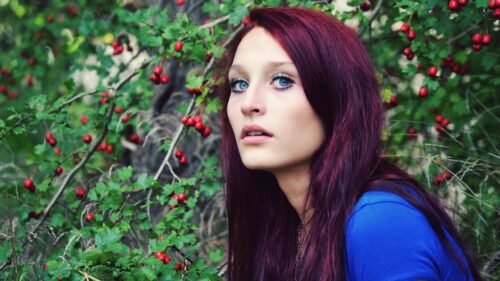 Stunning Woman with Crimson Hair in a Wild Berry Bush Desktop Wallpaper