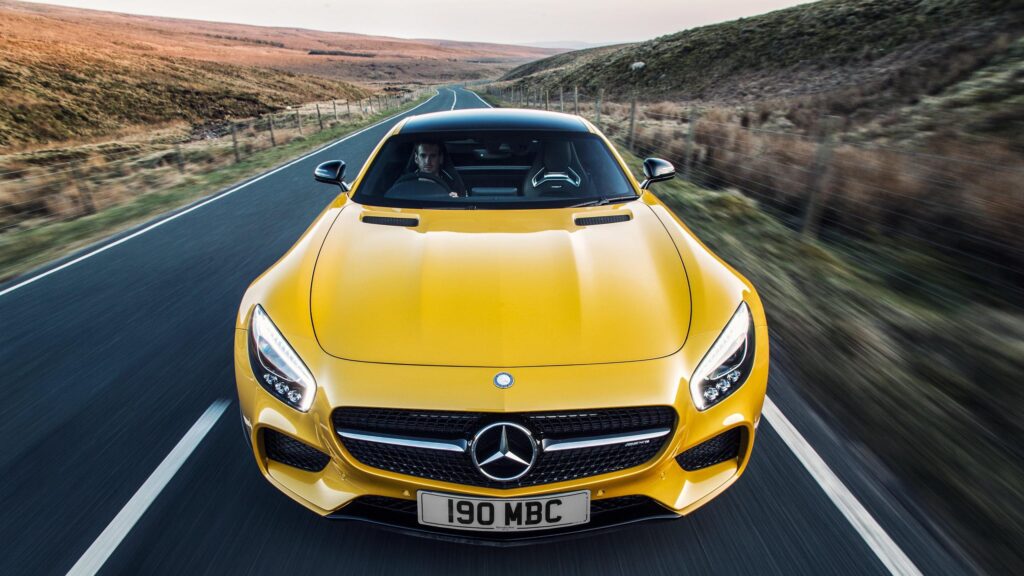 Stunning Yellow Mercedes-AMG GT Sports Car on Scenic Highland Road 4K Wallpaper