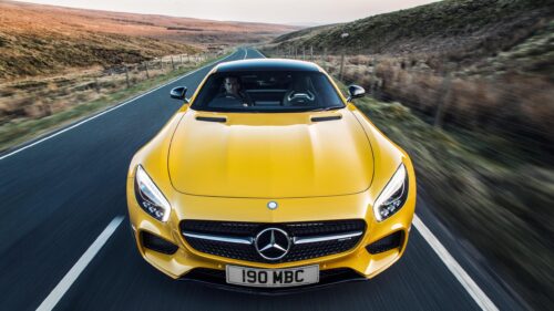 Stunning Yellow Mercedes-AMG GT Sports Car on Scenic Highland Road 4K Wallpaper