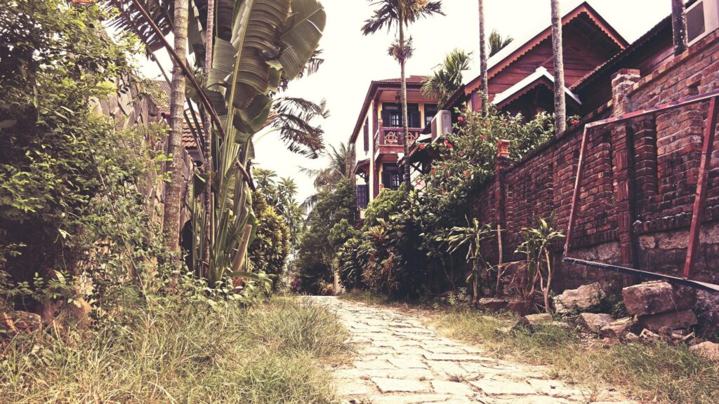 Rustic Stone Pathway Through Tropical Garden and Wooden Villa Desktop Wallpaper