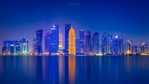 Stunning Doha City Skyline at Night Overlooking the Persian Gulf Desktop Wallpaper