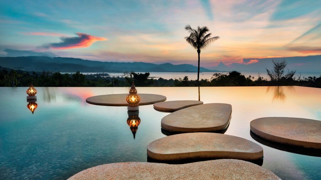 Stunning Infinity Pool Sunset with Decorative Lanterns Desktop Wallpaper