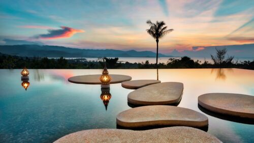 Stunning Infinity Pool Sunset with Decorative Lanterns Desktop Wallpaper