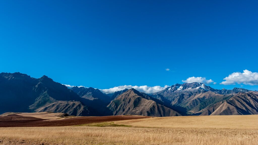 Stunning Andes Mountain Range with Golden Wheat Fields 4K Desktop Wallpaper