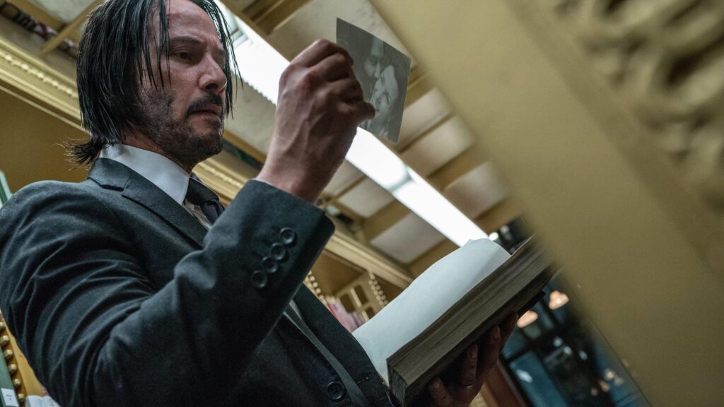 Keanu Reeves as John Wick Reading in Library Desktop Wallpaper 4K