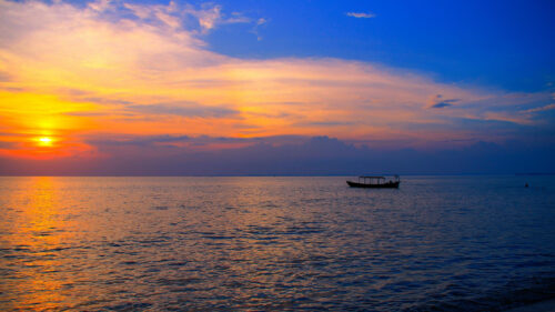 Stunning Sunset Ocean View with Silhouette Boat PC Wallpaper