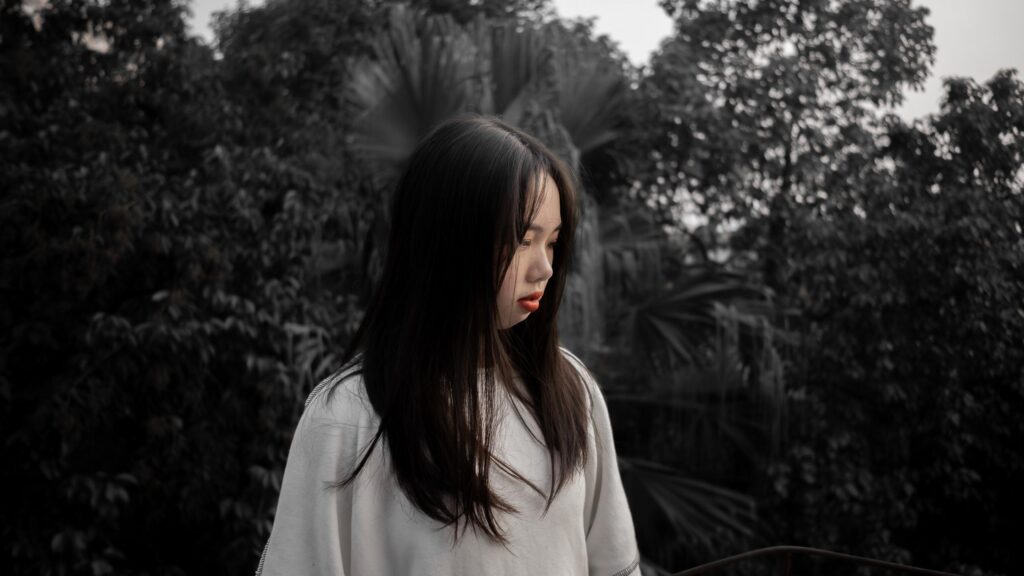 Melancholic Portrait of a Young Woman in Nature Desktop Wallpaper