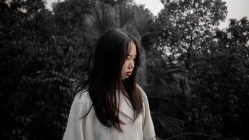 Melancholic Portrait of a Young Woman in Nature Desktop Wallpaper