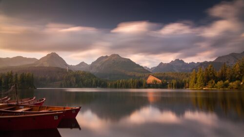 Stunning Strbske Pleso Lake with Wooden Boats and Mountain Sunset 4K Wallpaper