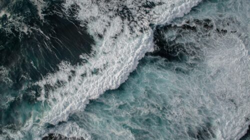 Aerial View of Deep Blue Ocean Waves and White Sea Foam Desktop Wallpaper