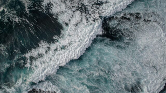 Aerial View of Deep Blue Ocean Waves and White Sea Foam Desktop Wallpaper