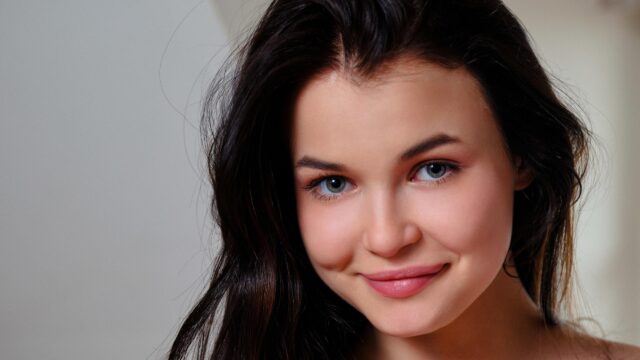 Stunning Portrait of a Beautiful Young Woman with Dark Hair 4K Desktop Wallpaper
