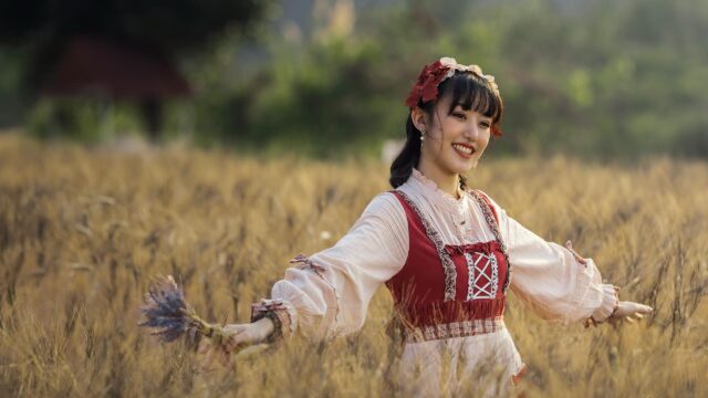 Beautiful Girl in Lolita Fashion Standing in a Golden Wheat Field 4K Wallpaper