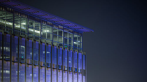 Modern Architectural Skyscraper Facade at Night 4K Desktop Wallpaper